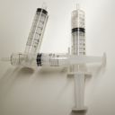Three empty syringe plungers arranged to form the digit four.